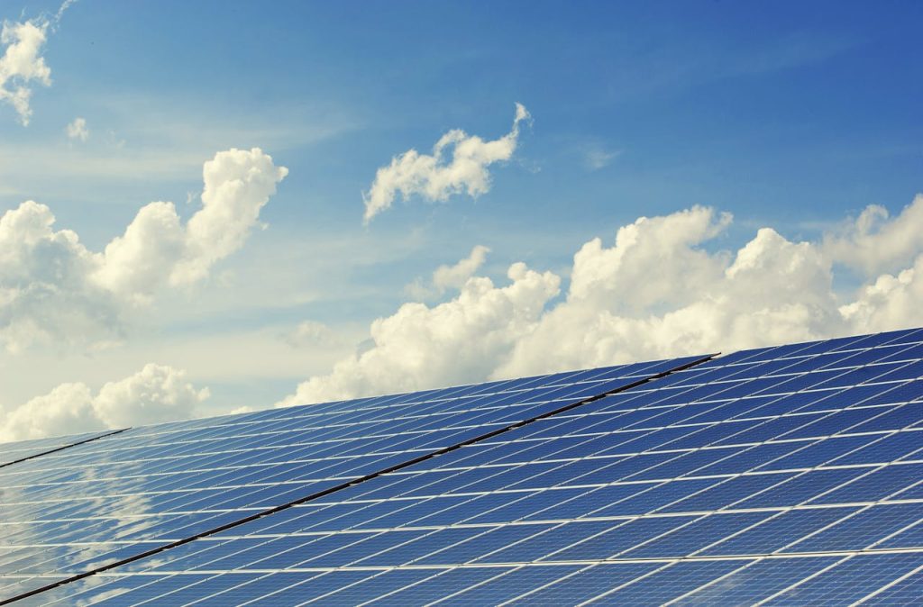 blue-solar-panel-board-356036 Sleek modern solar panels under a vibrant blue sky with clouds, symbolizing clean energy.